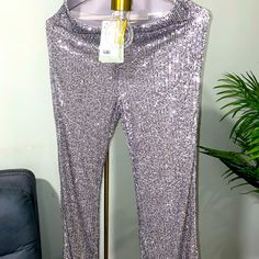 H&M Brand New Sequin Pants Perfect Condition All Pictures & Videos Are An Accurate Representation Of The Item. Please Thoroughly Examine All Pictures And Videos Prior To Purchasing :) Metallic Sequined Pants For Spring, Spring Sequined Metallic Pants, Glamorous Metallic Stretch Pants, Elegant Silver Sequined Pants, Metallic Stretch Bottoms With Sequins, Silver Fitted Pants For Party Season, Silver Sequined Pants For Night Out, Metallic Stretch Sequin Bottoms, Silver Fitted Pants For Night Out