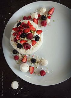 a white plate topped with fruit covered dessert