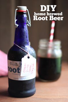 a bottle with a tag on it sitting next to a cup filled with root beer