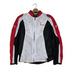 a white and black jacket on a hanger next to a red and white shirt