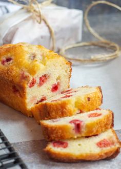 sliced loaf of strawberry bread sitting on top of a piece of paper next to a keyboard