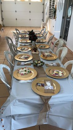 the table is set with plates and place settings for several people to sit down at