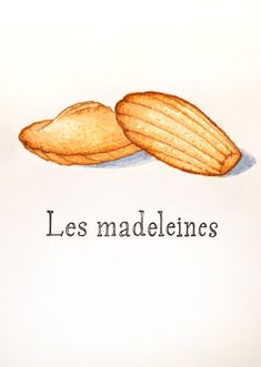 two pieces of bread sitting next to each other on top of a white paper with the words les madeleines written below it