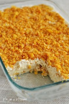 a casserole dish filled with food on top of a white cloth covered table