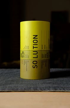 a yellow coffee cup sitting on top of a table