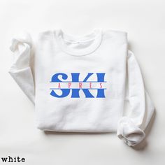 Cute and Cozy Après Ski Sweatshirt- Unisex sizing: Great for men or women! All sweashirt colors come with the blue/pink design,  except for the navy navy sweatshirt, which comes with green/yellow design. Message me BEFORE ordering for custom color combinations. Great for group destinations, skiing trips, family vacation, girls weekend, guys mountain getaway, bachelorette parties- the opportunities are endless! Cute Ski Crewneck Sweatshirt! Durable polyester and cotton blend for long-lasting wear White Crew Neck Sweatshirt For Winter Sports, Casual Tops For Winter Sports, Casual Graphic Print Tops For Winter Sports, Sporty Tops For Ski Season, Long Sleeve Tops For Ski Season And Winter Sports, Long Sleeve Tops For Ski Season, Sporty Top For Ski Season, Casual Winter Skiing Tops, Casual Skiing Tops