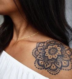 a woman with a tattoo on her shoulder