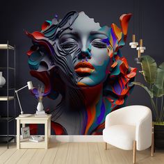 a room with a chair, table and large wall mural on the wall that has an image of a woman's face