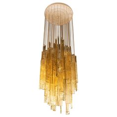 a large chandelier made out of glass tubes and gold lusted metal rods