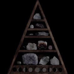 a wooden shelf filled with different types of rocks