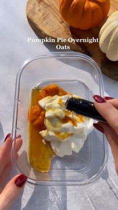 pumpkin pie overnight oats in a plastic container with whipped cream and caramel sauce