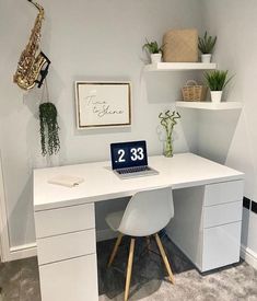 a white desk topped with a laptop computer