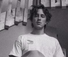 black and white photo of young man with skateboard