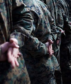 many soldiers are lined up with their hands together