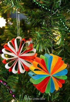 colorful ornaments hanging from a christmas tree in the shape of flower ornament decorations