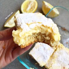 a hand holding a half eaten lemon cake