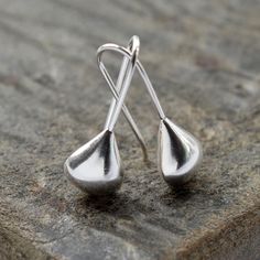 These beautifully simple Sterling Silver April Shower Drop Earrings have a silver liquid metal effect giving them the fresh flowing appearance of a raindrop. Our contemporary design silver teardrop earrings are simply made to wear with an easy, no fuss fixed hook drop setting. The polished finish and silver liquid metal effect make the earrings appear like recently formed drops of april rain slowly moving over a leaf.  All Martha Jackson jewellery is beautifully presented in a gift box complete with a blank gift card for you to write a short message on. made from: Sterling silver with a polished finish. Keep clean with an anti tarnish cloth. dimensions: Overall length 2cm. Teardrop width 0.7cm. Modern Nickel-free Teardrop Earrings, Modern Hypoallergenic Teardrop Drop Earrings, Modern Silver Teardrop Pendant, Minimalist Long Drop Hypoallergenic Earrings, Modern Hypoallergenic Teardrop Earrings, Minimalist Hypoallergenic Long Drop Earrings, Modern Teardrop Earrings With Pearl Drop, Minimalist Silver Hypoallergenic Teardrop Earrings, Minimalist Silver Long Drop Teardrop Earrings