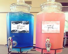 two large jars filled with liquid sitting on top of a metal rack next to each other