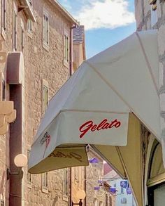 an umbrella that is on the side of a building