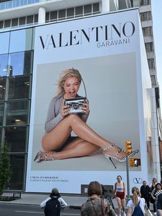 a large advertisement on the side of a building for a women's clothing store