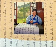 a woman sitting at a table with writing on it