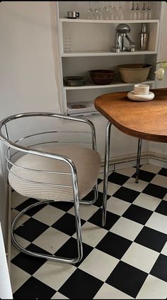 two chairs and a table in a room with black and white checkered flooring