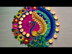 a colorful peacock made out of candles on a table