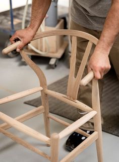 a man working on a wooden chair