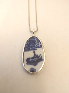 Broken China Jewelry Broken China Pendant Broken China Necklace    Broken China Jewelry, Pendant. Sterling Silver, "BLUE WILLOW BOAT" 1 15/16" Inches Long   15/16" Inches Wide  Every piece of broken china is unique and carefully handcrafted . Each piece is stamped with the artists name. All pieces are bezelled in fine silver. Bail and backing are Sterling silver . Broken Pottery Jewelry, Boat Necklace, Broken China Jewelry, Stone Harbor, China Jewelry, Broken China, Meaningful Jewelry, Blue Willow, China Patterns