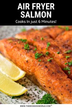 air fryer salmon on a plate with lemon wedges and parsley