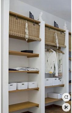 an organized closet with baskets and clothes hanging on the shelves, along with other items