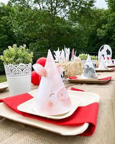 a table set up with plates and napkins for an animal themed birthday party or baby shower