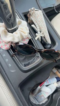 sunglasses and other items are sitting in the car