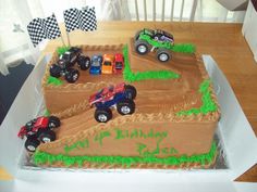 a birthday cake with monster trucks on it