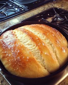 a loaf of bread sitting in a pan on top of a stove