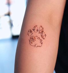 a person with a tattoo on their arm that has cats and dogs in the center