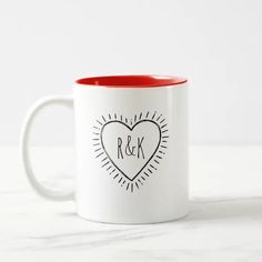 a white and red coffee mug with the word r & k printed on it's side