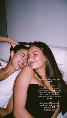 two women laying next to each other on top of a white bed with a quote