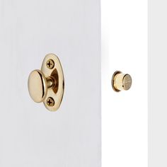 an open door with two knobs on the front and back of it, both in gold