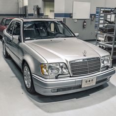 a silver mercedes benz parked in a garage