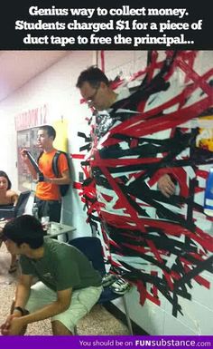 two men working on a large piece of art with red and black strips attached to it