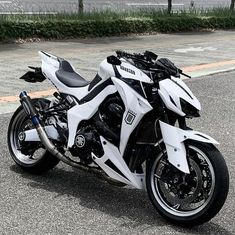 a white and black motorcycle parked on the street