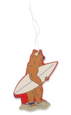 an ornament with a bear holding a surfboard on it's back