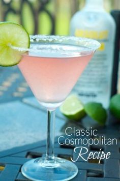 a pink drink with limes on the side