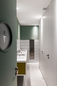 a bathroom with two sinks and a large mirror in the wall next to each other