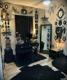 a living room filled with lots of black furniture and decorations on the wall above it