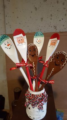 a group of spoons that are sitting in a cup filled with candy canes