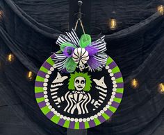 a starbucks sign hanging from the side of a building with lights on it's sides