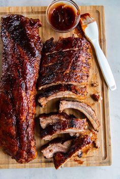 bbq ribs and barbecue sauce on a cutting board