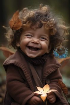 a smiling child with curly hair holding a flower